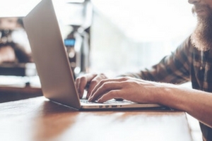 Man using a laptop in a cafe